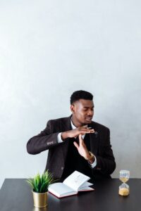 man in black suit jacket smoking cigarette