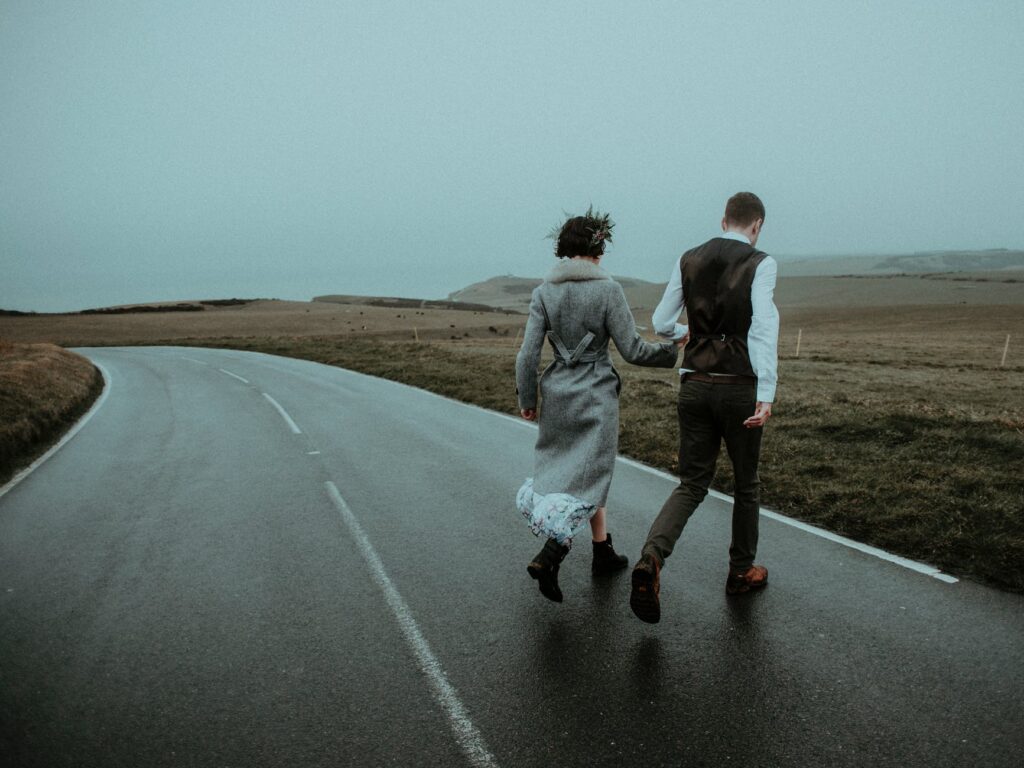 photo of couple walking on road
